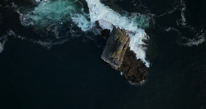 Top down aerial view of Branaunmore sea stack and Atlantic waves, Cliffs of Moher, Ireland