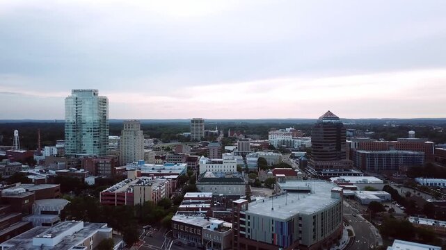 Aerial view of Durham North Carolina downtown skyline at dusk showing modern architecture and urban streets.