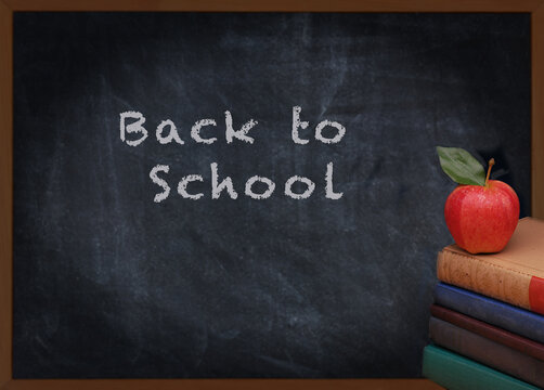 Back to school or education concept. Books, Apple and Chalkboard