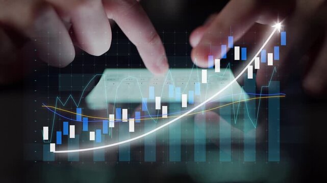 Close-up of hands interacting with a touchscreen device displaying stock market data and financial charts, showcasing growth trends and trading analytics. Copula