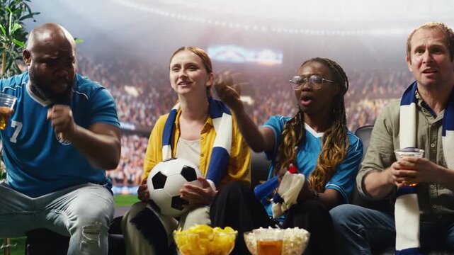 Passionate soccer fans celebrate goal and enjoy stadium experience while watching match at home as thrilled football supporters react to favorite team win and stadium crowd energy.
