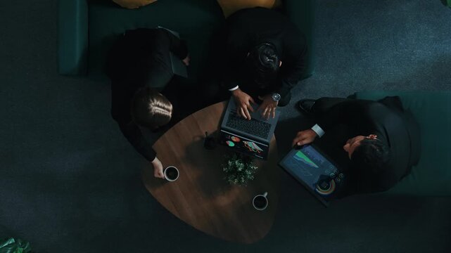 Top down aerial view of skilled female investor hold financial chart while attend in meeting while smart manager discuss marketing strategy.and compare financial investment data report. Directorate.