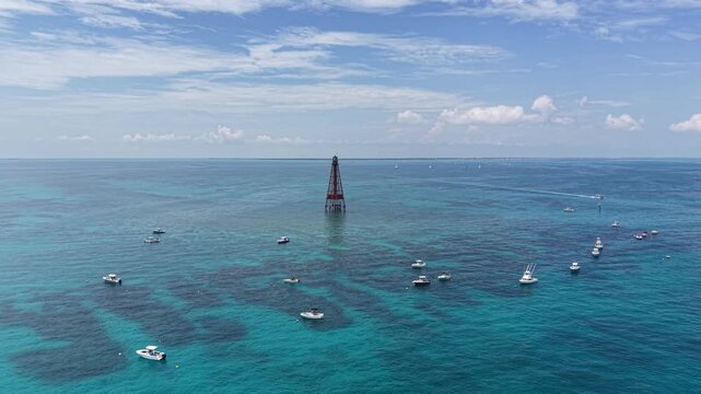 Boaters anchored off Sombrero Key Reef Lighthouse near Marathon in the Florida Keys.