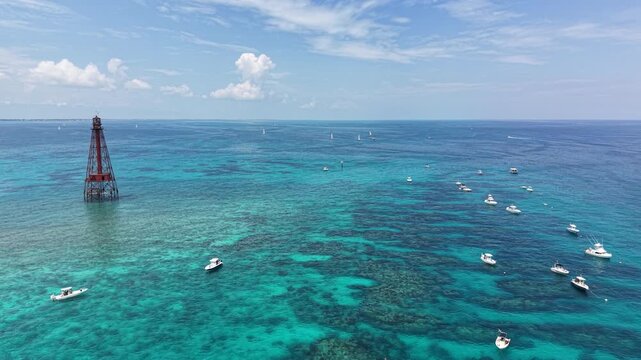 Boats with divers and snorkelers anchored off Sombrero Key Reef Lighthouse near Marathon in the Florida Keys.