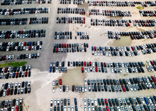 Aerial view of crowded parking lot with new cars