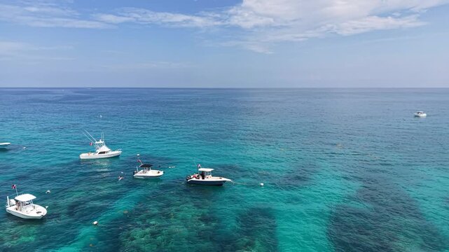 Boats moored along the reef at Sombrero Key Lighthouse offshore from Marathon in the Florida Keys.