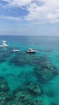 Boats moored along the reef at Sombrero Key Lighthouse offshore from Marathon in the Florida Keys.