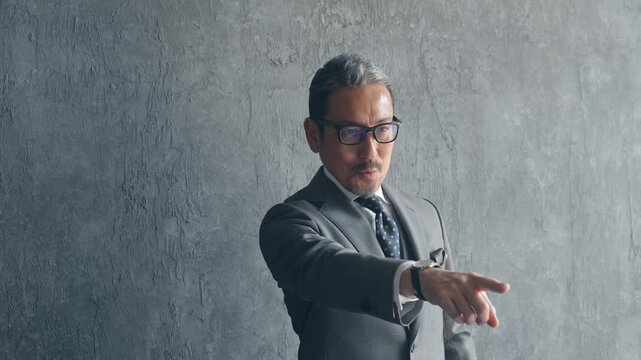 指をさすミドル男性ビジネスパーソン。指導、目標、社長、経営者、リーダーシップ、挑戦、チャレンジ、指示