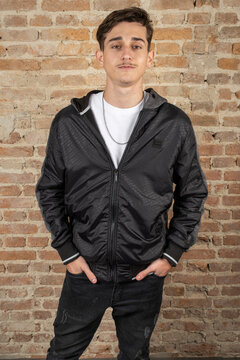 19 year old Brazilian young man wearing a jacket and looking at the camera.
