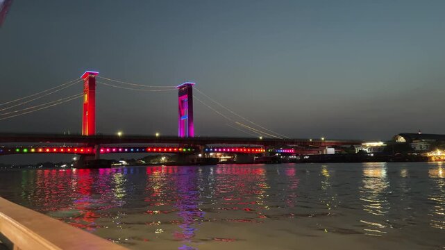 Ampera Bridge at night with colorful lights in Palembang, Indonesia