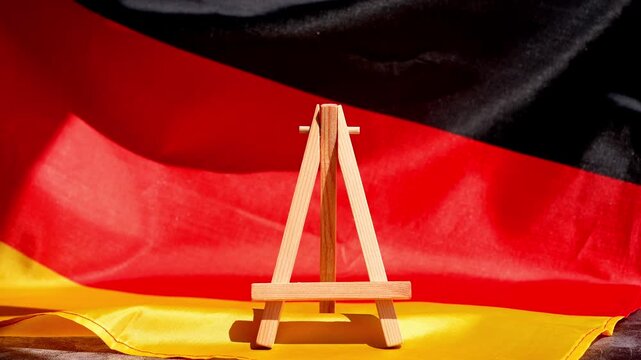 Paper note with words EXPORT on National symbol of Germany. German wave silky flag background. Concept of economy industry global market international shipping