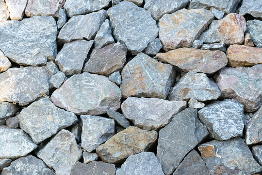 Closeup of natural crushed stones rough gray surfaces irregular shapes creating durable rock texture background for construction landscaping design