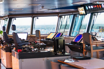 Modern maritime control room with radar equipment and navigation technology inside a commercial cargo vessel. © Mariusz
