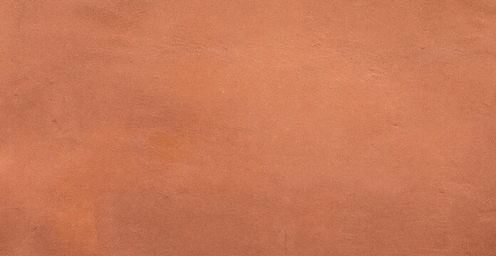 A smooth texture of orange clay or terracotta, showcasing a warm earthy tone that adds depth and character to various design projects.