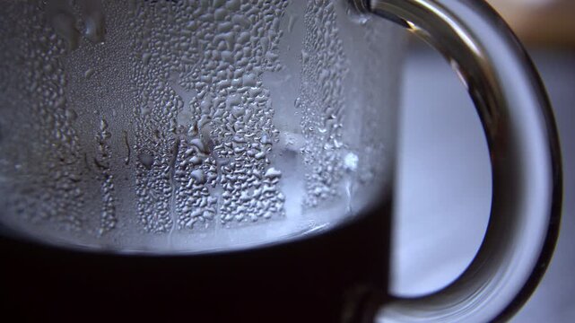 Close-Up of Water Condensation Inside a Glass Coffee Carafe with Moisture Droplets and Steam