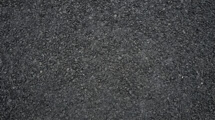 Fototapeta premium Macro view of dark gray crushed stone asphalt texture surface.