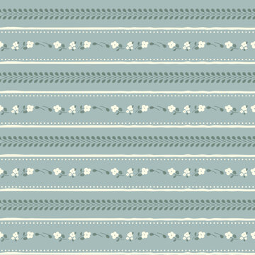 Cute floral seamless pattern background with horizontal stripes, green leaf vines, tiny white flowers on sage blue backdrop. Shabby chic hand drawn wallpaper, vintage cottagecore fabric design.