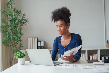 Professional woman analyzing data working on laptop
