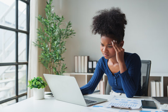 Woman experiencing stress and headache from work overload