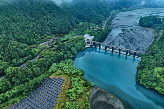 Aerial drone photo of dam, river, and solar panels in rural Shizuoka, Japan