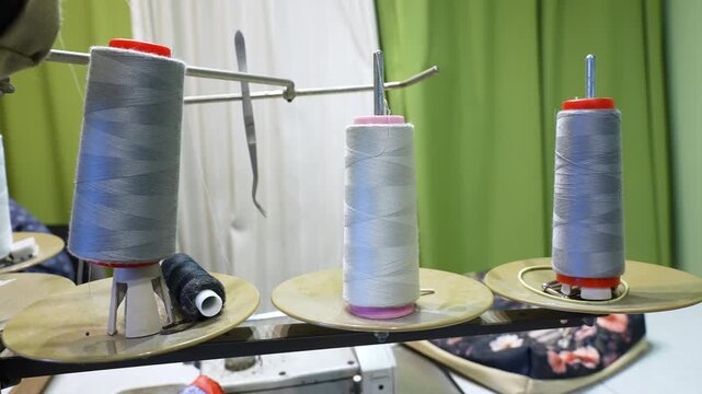Multiple thread bobbins on a spool holder of an industrial sewing machine