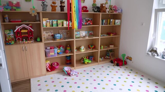 Interior of a bright, empty kindergarten classroom filled with educational toys and books