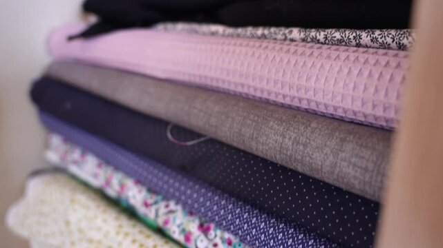 Assorted collection of colorful fabrics with different patterns and textures for tailoring