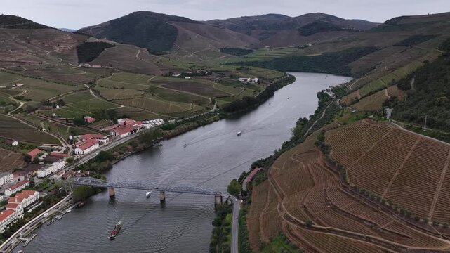 Drone shot of Pinhao village in Douro valley with a lot of cruiseship boats on the Douro river.
