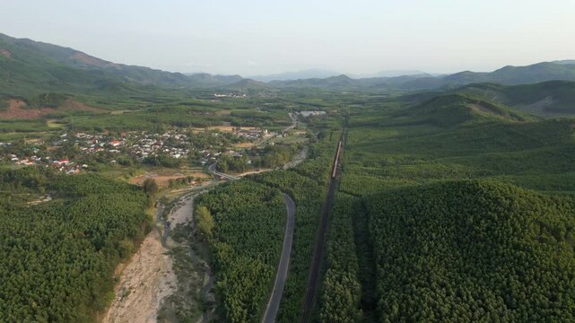 War Torn Mountains Of Dak Lak Province Central Vietnam Freight Train Heads Towards Horizon Drone 4K 30FPS