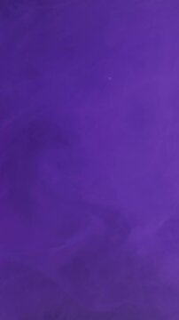 Vertical video. Color smoke. Paint water splash. Defocused neon purple fume wet cloud chemical fluid vapor spreading on abstract art background.