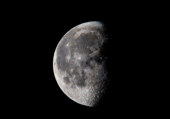 Detailed view of the moon's surface showing craters and maria against a black sky © EJ