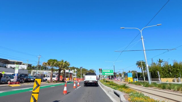 Vehicle Driving Through Road Construction Zone on Sunny Australian Street