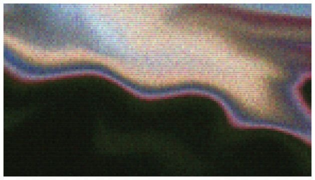 Technicolor halftone wave over dark background with spectrum colors.