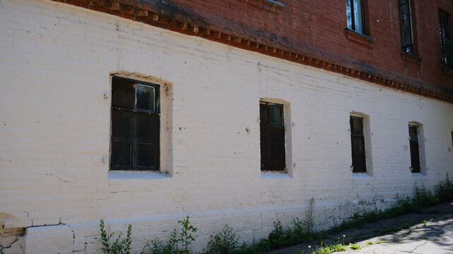 An old window of an old house. Against the background of white walls.