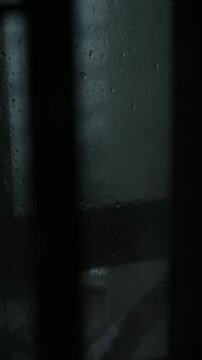 Melancholic Rainy Day Rain Drops Streaming Down Window Glass with Blurred City Buildings, Lonely Sad Moody Urban Monsoon Mood 
