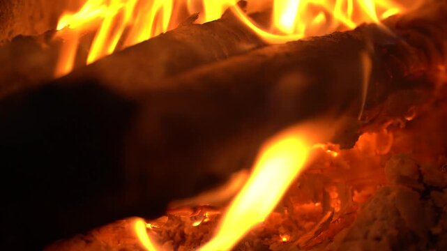 Close-up of Bright Orange Flames Burning on Wood Logs in a Fireplace
