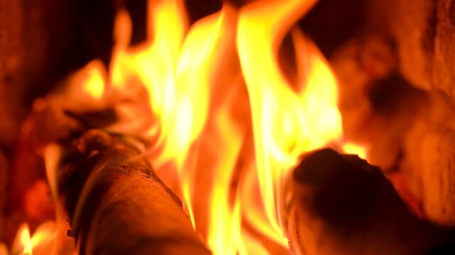 Close-up of Bright Orange Flames Burning on Wood Logs in Fireplace