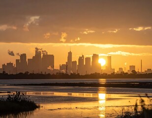 Obraz premium Breathtaking Sunset Over City Skyline Reflected in Water with Silhouettes of Buildings