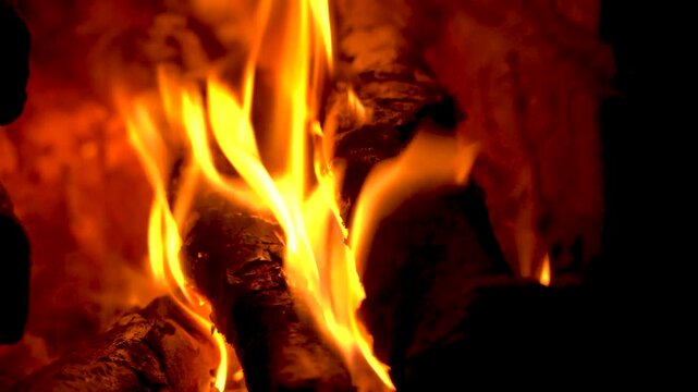 Close-up of Bright Orange Flames Burning on Wood Logs in Fireplace