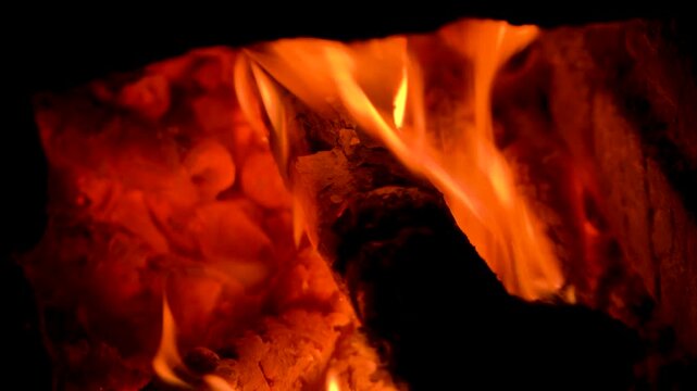 Close-up of Bright Orange Flames Burning on Wood Logs in Fireplace