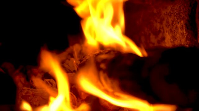 Close-up of Bright Orange Flames Burning on Wood Logs in Fireplace