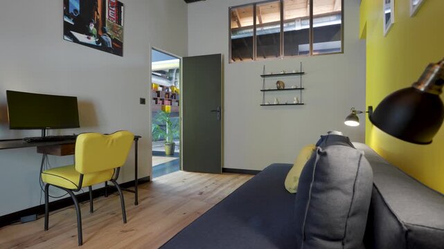 Interior office space with desk couch and yellow chair dynamic motion footage.