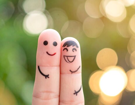 A creative photo of two fingers with smiley faces