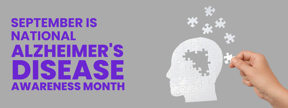 Hand with puzzle piece above jigsaw head for dementia