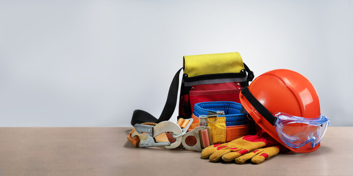 Personal protective equipment on light grey background with place for text.
