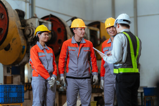 Team discusses safety measures in a factory during a work meeting