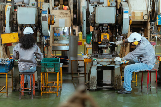 Team discusses safety measures in a factory during a work meeting