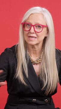 Elegant senior businesswoman speaking about positive longevity