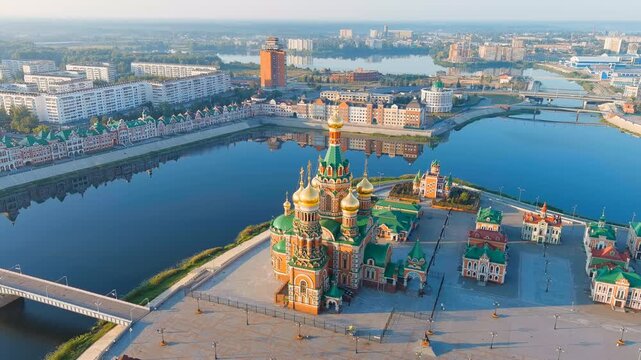 Yoshkar-Ola, Russia. Cathedral of the Annunciation of the Blessed Virgin Mary, five gilded onion domes rising above the Malaya Kokshaga River embankment, Drone footage in soft morning light. Drone fo
