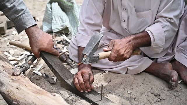 Carpenter Hammering Nail into Wooden Beam During Construction Work &ndash; Skilled Craftsman Using Hand Tools on Timber Project 4K Footage